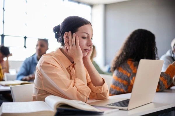 Female college student looking distracted during a lesson at school